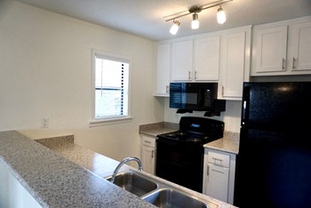 Black kitchen appliances at Hilltop Commons Apartments in San Pablo CA